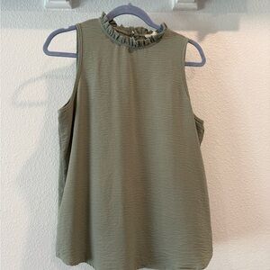 Sage green sleeveless blouse. High neck with dainty ruffle detail. Medium